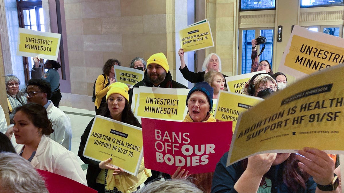 Abortion protesters on both sides pack the halls outside the Minnesota Senate chamber on Friday, Jan. 27, 2023, at the State Capitol in St. Paul, Minn.