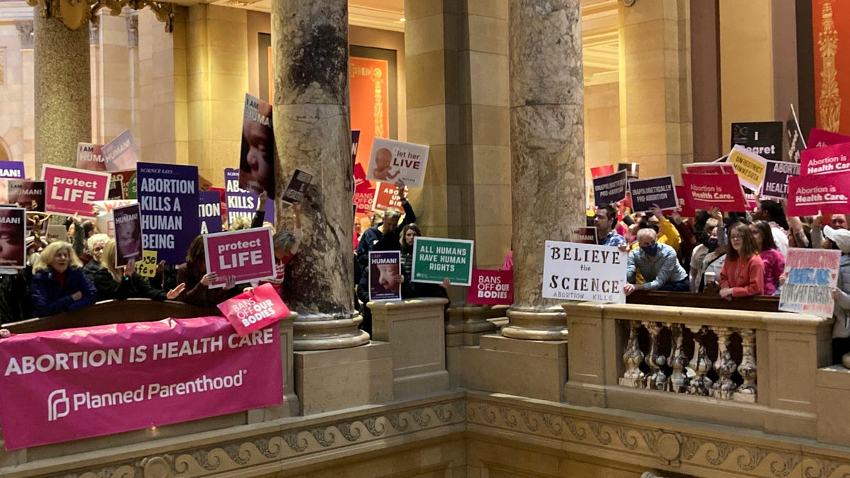 Abortion protesters on both sides pack the halls outside the Minnesota Senate chamber on Friday, Jan. 27, 2023, at the State Capitol in St. Paul, Minn.