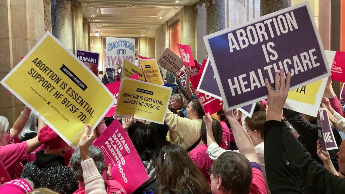 Abortion protesters on both sides pack the halls outside the Minnesota Senate chamber on Friday, Jan. 27, 2023, at the State Capitol in St. Paul, Minn