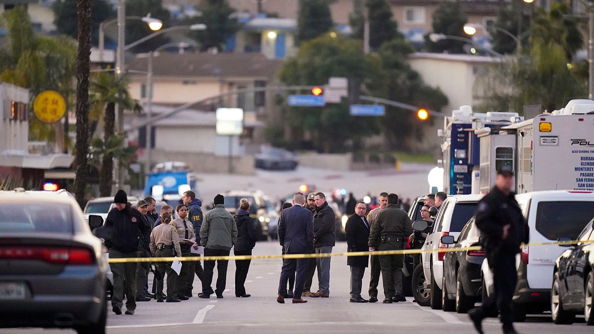 law enforcement on street with police tape blocking