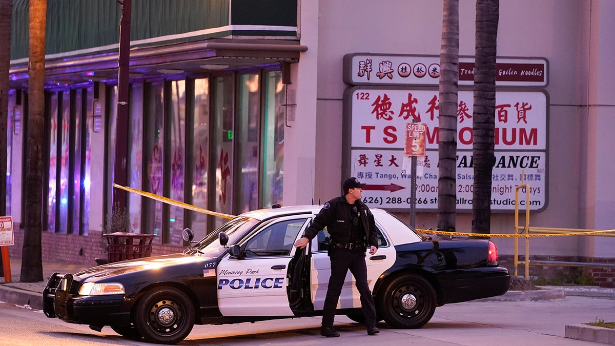 police officer closing car door at scene