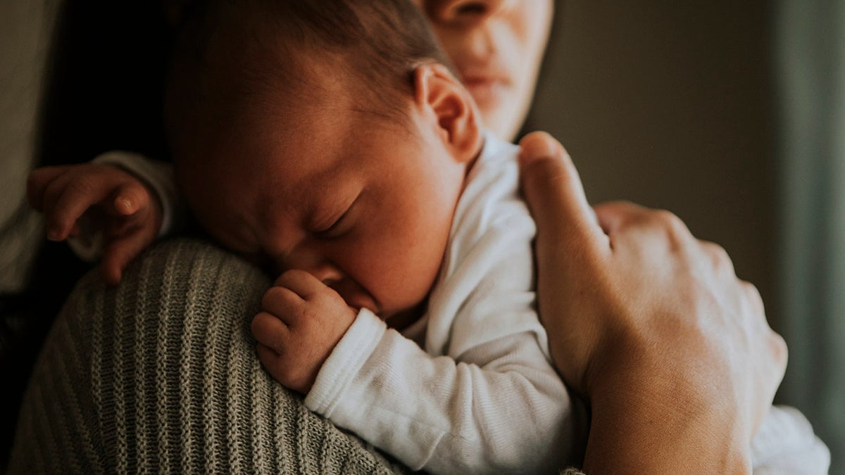 mother holding baby