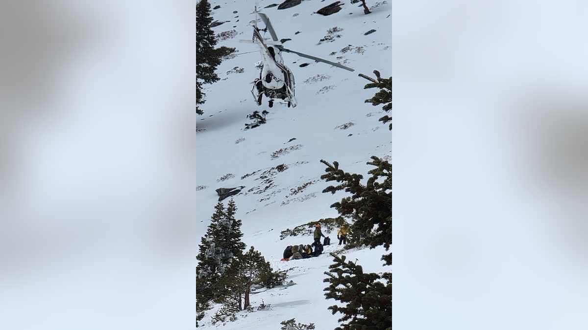 helicopter flying over icy hillside