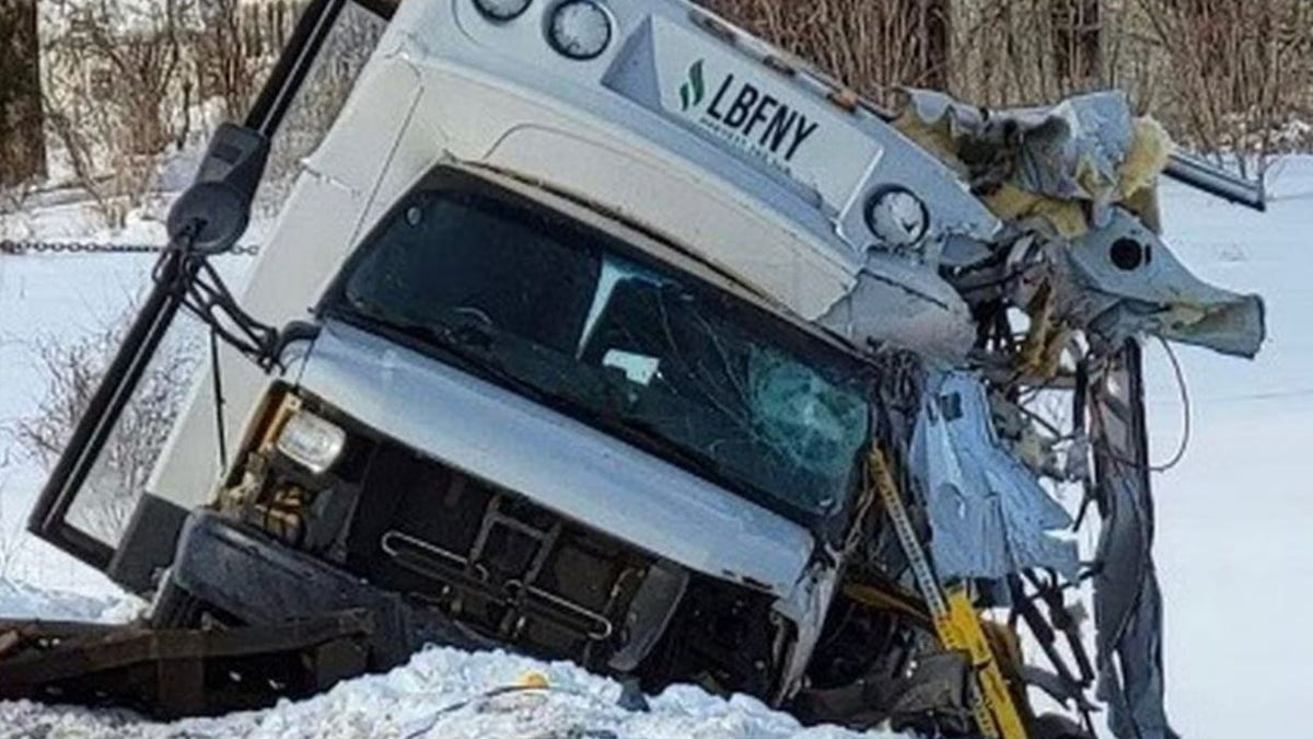 crashed bus on the side of the highway