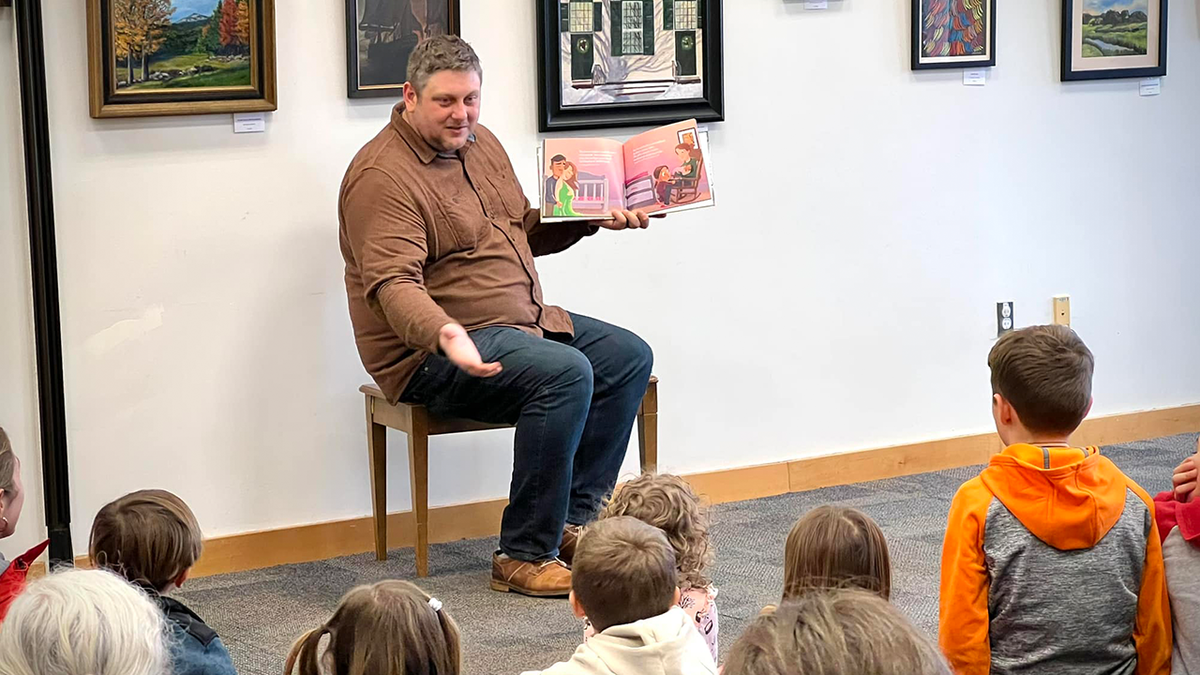 Kendall Lankford reading christian books at chelmsford public library