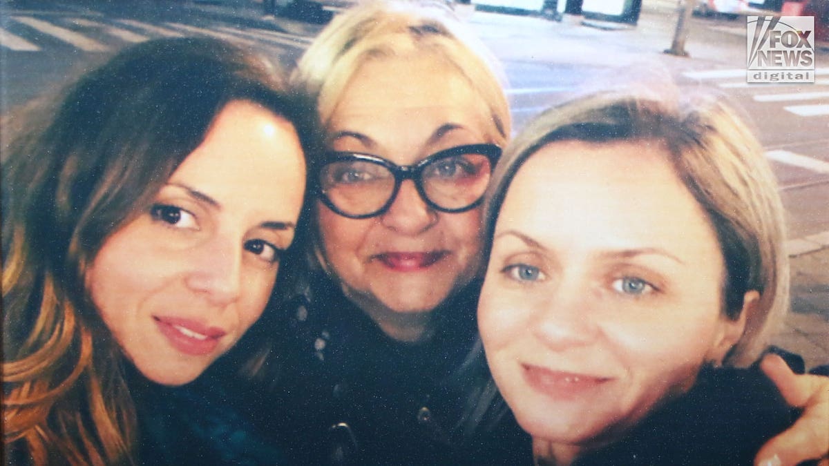 A selfie-style photo of woman with her two daughters