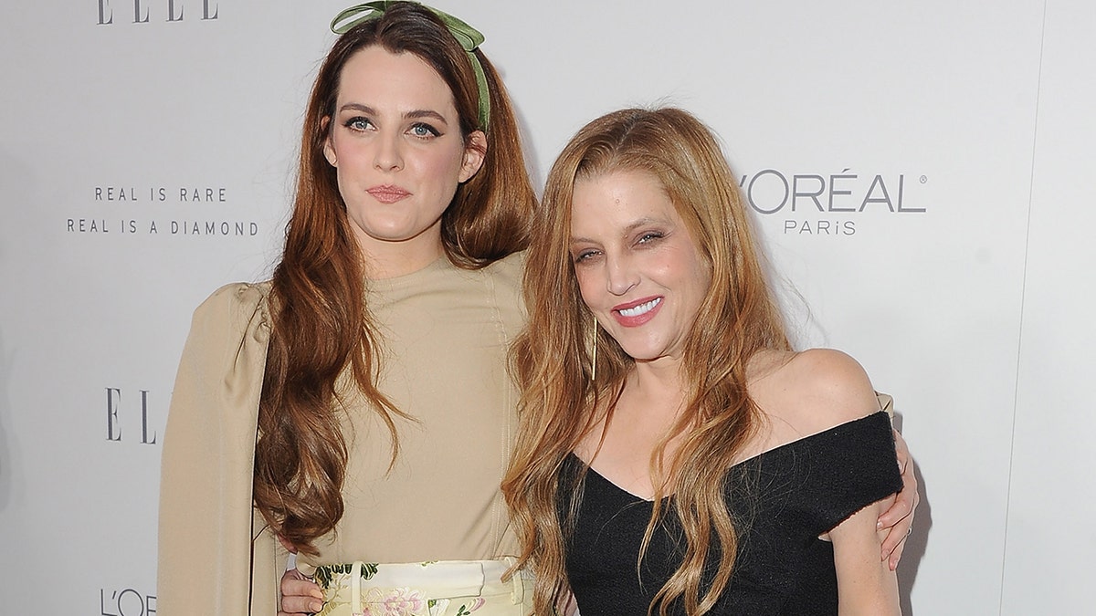 Riley Keough and Lisa Marie smiling on a red carpet together