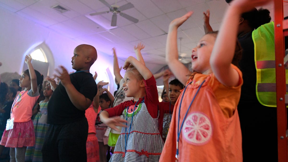 Youth participants dance and sing during the last night of the Lighthouse Christian Center vacation bible school in West Reading on Thursday, July 12, 2018.