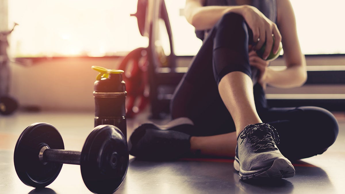 woman sitting down at the gym