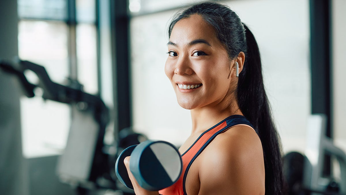 woman lifting weights health and fitness