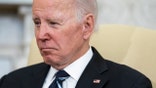 A photo of Joe Biden sitting