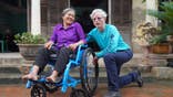 Don Schoendorfer, founder of Free Wheelchair Mission, with a woman in Vietnam.