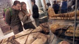 Visitors view some of the Egyptian mummies at the British Museum in London.