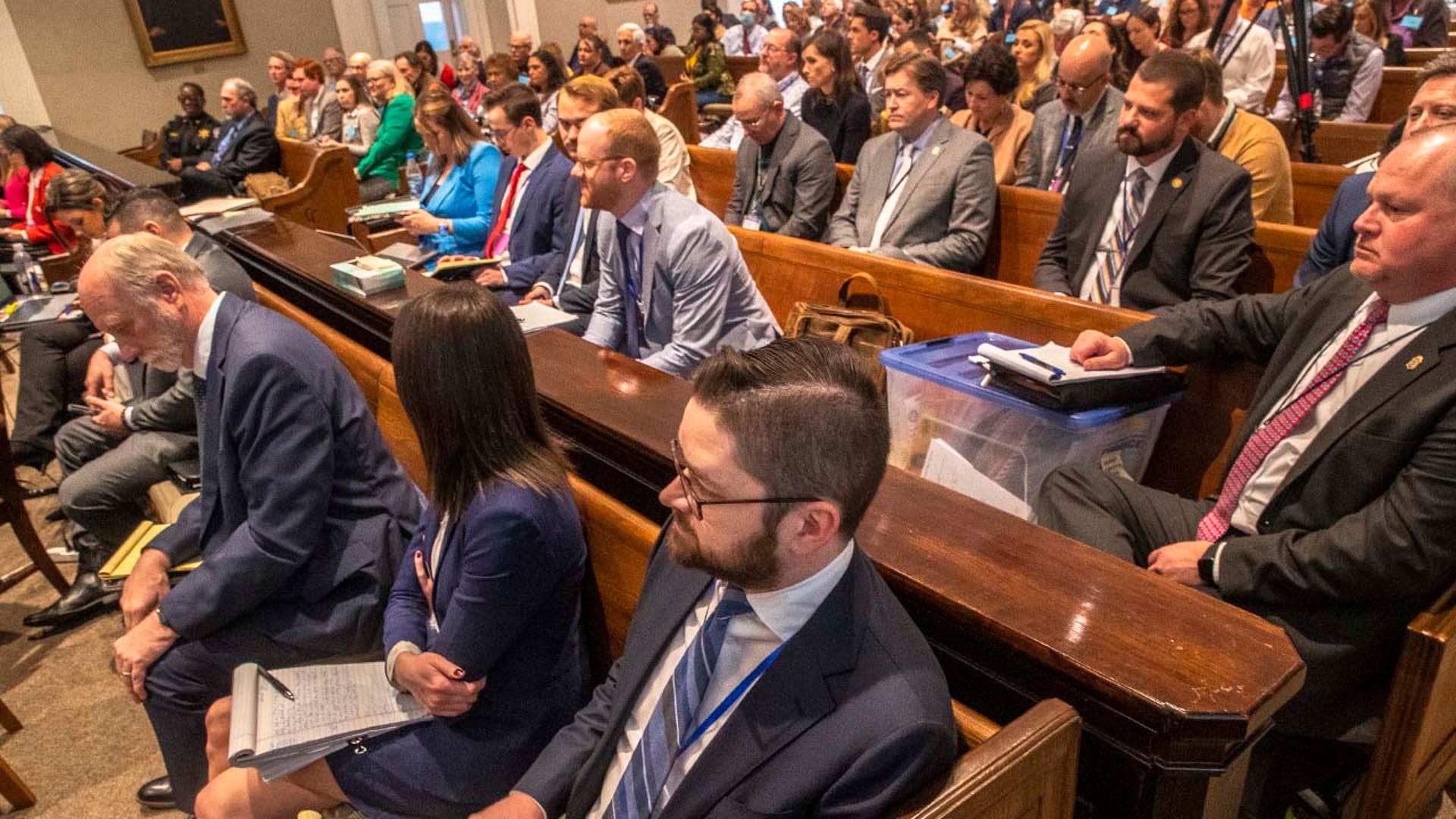 A packed gallery inside a courtroom.