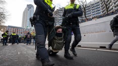 Climate change protesters in The Hague block highway, get detained and hauled away by bus