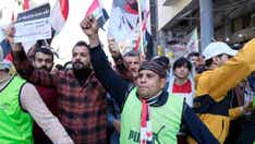 Iraqi protestors rally near the country's central bank regarding the recent devaluation of the dinar