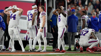 Buffalo Bills players react as teammate Damar Hamlin is examined