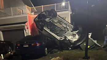 New Jersey police release dramatic video of stolen car going over guardrail and crashing on house, car