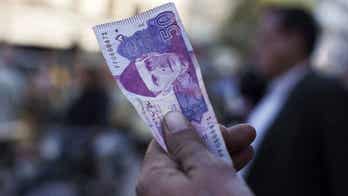 Pakistan's rupee plummets against the dollar as country's government agrees to comply with IMF