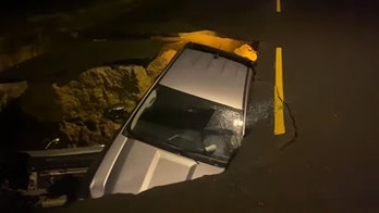 California sinkhole swallows 2 cars, firefighters rescue trapped mother and daughter