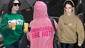 Alec Baldwin gets support from Hilaria in new photos as she wears 'boundaries' top amid his criminal charges