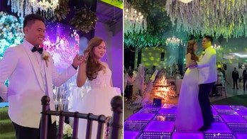 'Hot' first dance: Newlyweds sway to music as decorative display behind them bursts into flames