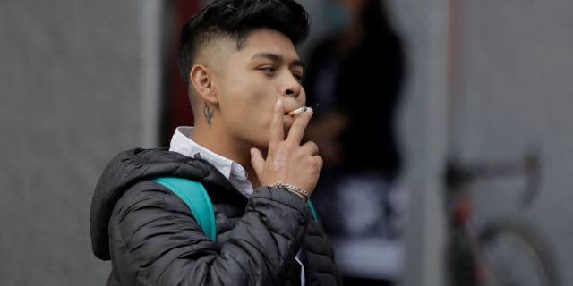 A young man smoking a cigarette in the streets of Mexico City during World No Tobacco Day in Mexico.