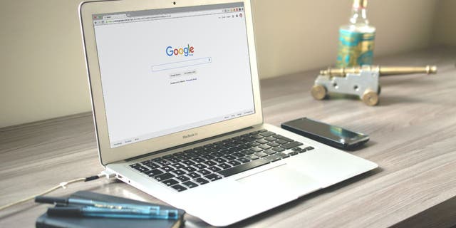 A laptop is opened up to the Google search engine.