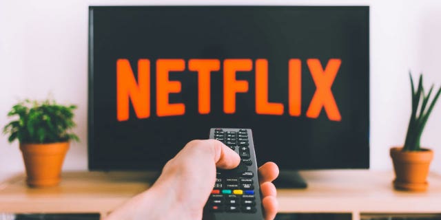 Photo of someone turning on Netflix.