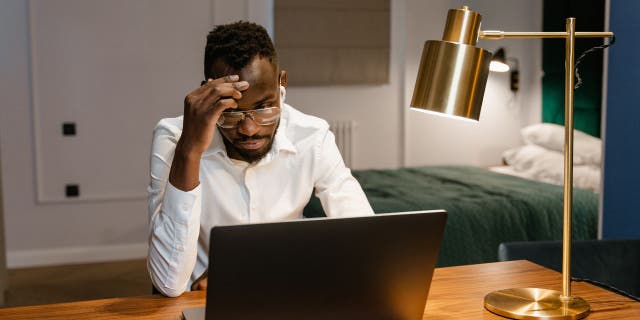 Man stressed on laptop