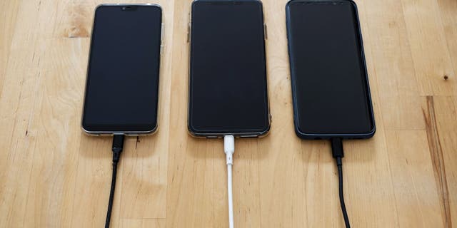 All three phones are plugged in.
