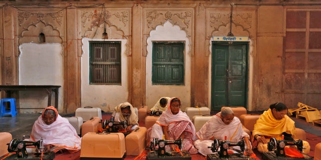 Widows with their sewing machines attend a training class at the Meera Sahavagini ashram in the pilgrimage town of Vrindavan in the northern Indian state of Uttar Pradesh March 6, 2013.