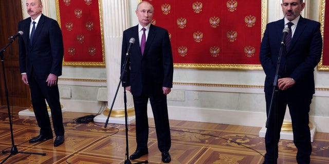 Russia's President Vladimir Putin, center, Azerbaijan's President Ilham Aliyev, left, and Armenia's Prime Minister Nikol Pashinyan attend a news conference following their meeting to discuss the implementation of the ceasefire over Nagorno-Karabakh reached on November 9 and measures to solve problems in the region, in Moscow Jan. 11, 2021. 