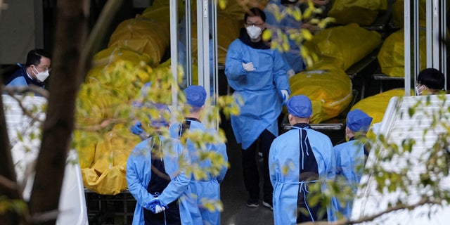 A staff member walks next to several body bags at a funeral home, as COVID-19 outbreaks continue in Shanghai, China, January 4, 2023.