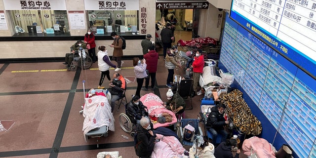 Patients lie on beds and stretchers in a hallway in the emergency department of a hospital, amid the COVID-19 outbreak in Shanghai, China January 4, 2023. 