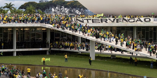 Supporters of Brazil's far-right former President Jair Bolsonaro who contests the election of leftist President Luiz Inacio Lula da Silva gather at Planalto Palace after invading the building as well as the Congress and Supreme Court, in Brasilia, Brazil Jan. 8, 2023.