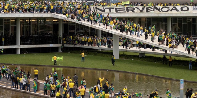Supporters of Brazil's far-right former President Jair Bolsonaro who dispute the election of leftist President Luiz Inacio Lula da Silva gather at Planalto Palace after invading the building as well as the Congress and Supreme Court, in Brasilia, Brazil Jan. 8, 2023.