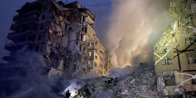 Rescuers work at the site where an apartment building was heavily damaged by a Russian missile strike, amid Russia's attack on Ukraine, in Dnipro, Ukraine Jan. 14, 2023.