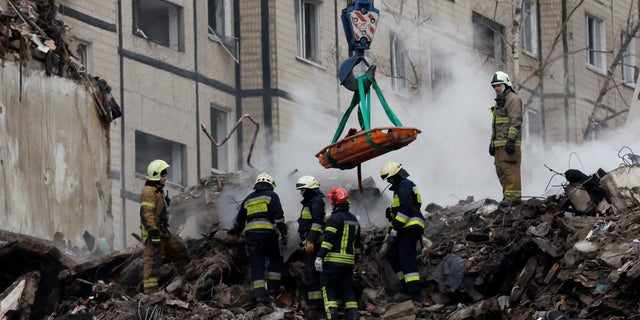 Emergency personnel at the site where an apartment block was heavily damaged by a Russian missile strike, amid Russia's attack on Ukraine, in Dnipro, Ukraine January 15, 2023. 