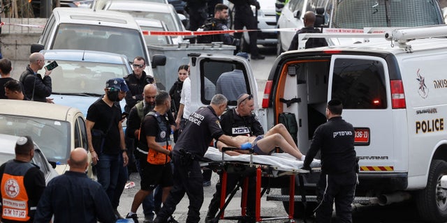 A person is wheeled on a stretcher at a scene where a suspected incident of shooting attack took place, police spokesman said, just outside Jerusalem's Old City January 28, 2023.