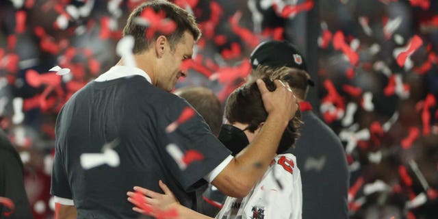 Tom Brady of the Tampa Bay Buccaneers celebrates with son John Moynahan after defeating the Kansas City Chiefs in Super Bowl LV at Raymond James Stadium Feb. 7, 2021, in Tampa, Fla.