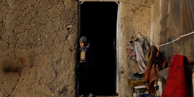 Sister of Amrullah, a three-month-old who died due to the cold, stands at her home in Kabul, Afghanistan, on Jan. 30, 2023.