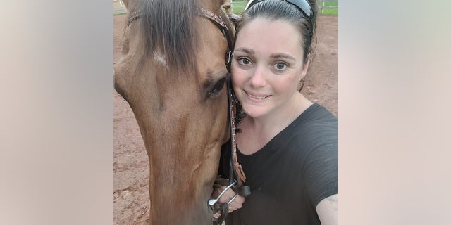 Allison Holthoff with her horse, which she fell off in September 2022, resulting in months of chronic pain that only got worse over time.