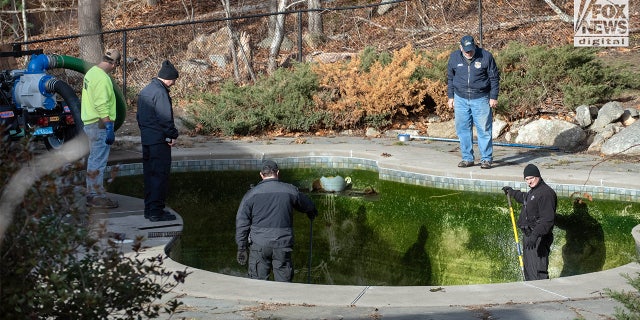 Individuals could be seen draining the pool at Ana Walshe's Cohasset home; Walshe has been missing since New Year's Day. 