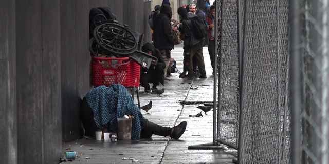 Drug users and dealers occupy a bus stop in San Francisco.
