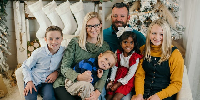 The owner of Geraldine Drugs, Brooke Walker (second from left), poses with her family at Christmas.  For a decade, Walker helped Hody Childress, a veteran, use his own money to help neighbors pay their medical bills.  The woman did not want anyone to know. 