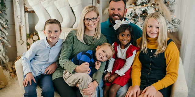 The owner of Geraldine Drugs, Brooke Walker (second from left), poses with her family at Christmas. For a decade, Walker helped Hody Childress, a veteran, use his own money to help neighbors pay their medical bills. The woman did not want anyone to know.