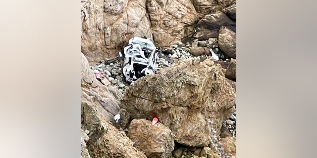 This image from video provided by San Mateo County Sheriff's Office shows a Tesla vehicle that plunged off a Northern California cliff along the Pacific Coast Highway, Monday, Jan. 2, 2023, near an area known as Devil's Slide, leaving four people in critical condition, a fire official said.