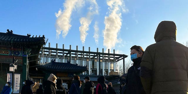 Mourners stand outside a crematorium in Beijing on December 31, 2022.