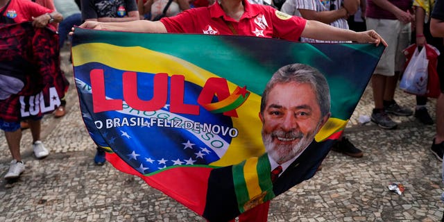 A supporter of Luiz Inacio Lula da Silva displays a banner during his inauguration as new president outside the Planalto presidential palace in Brasilia, Brazil, Sunday, Jan. 1, 2023. 